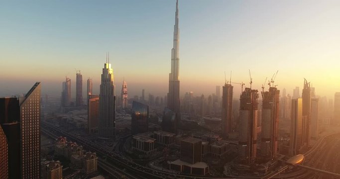 DUBAI, UAE - JANUARY 2, 2017: Aerial view of Burj Khalifa downtown Dubai at sunset. The Burj al Khalifa is the tallest structure in the world, standing at 829.8 m (2,722 ft). Scenic dusk 4K scene.