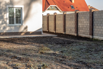 Land under construction, closed by a fence.