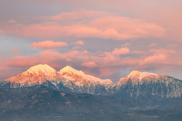 Fototapeta na wymiar Mountain peeks of Kocna,Grintavec and Kalski greben in Kamnik-Savinja Alps just before the sunset, with the afterglow lit sky viewed from Kranj, Slovenia