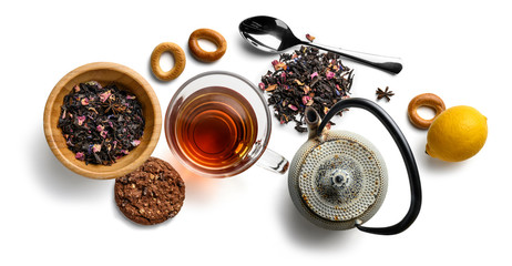 Black tea with natural aromatic additives and accessories. Top view on white background
