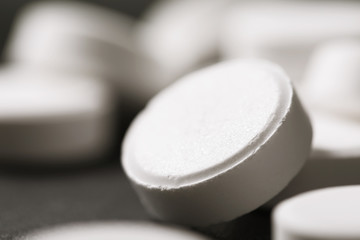 Macro photo of a white pill. Medicine on the table