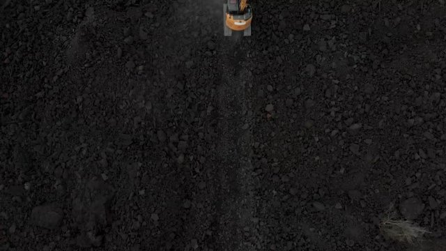 aerial reveal of excavator in puna Hawaii creating new road over fresh lava flow
