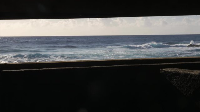ocean reveal through window slide right past columns