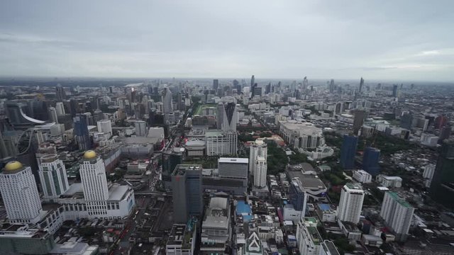 Slow panning right of Bangkok city from the top of skyscraper with clear stunning view of buildings and landmarks