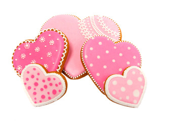 Background from pink cookies heart shaped with different patterns, isolated