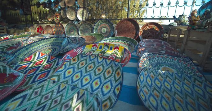 Sale of colorful national ceramic plates (lyagan) at the Chorsu bazaar in the old town of Tashkent Uzbekistan Central Asia.