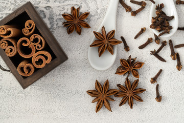 Different spices cinnamon, cloves, star anise on white background. Traditional Christmas smell and baking ingredients background.