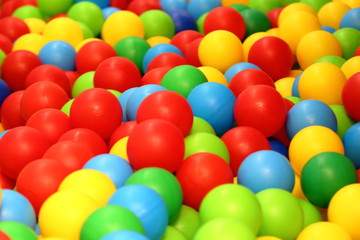 Fototapeta na wymiar colorful plastic balls on blue background