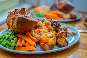  Selective focus on a traditional roast lunch on a blue oval dinner plate
