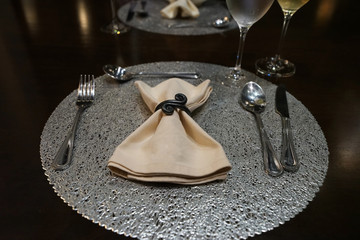 Table arrangement and setting on wooden table with stainless steel cutlery