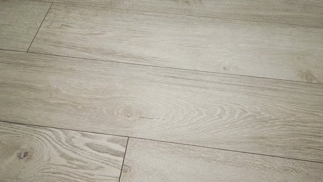 laminate flooring in light color wood. camera movement along the floor