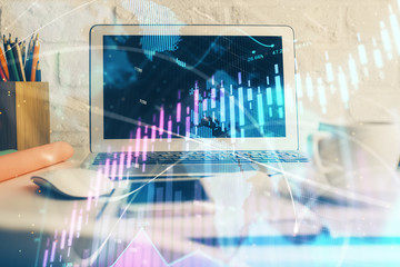 Stock market graph and table with computer background. Double exposure. Concept of financial analysis.