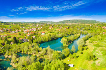 Croatia, beautiful green countryside landscape, Mreznica river from air, aerial drone view of Belavici village and waterfalls in spring