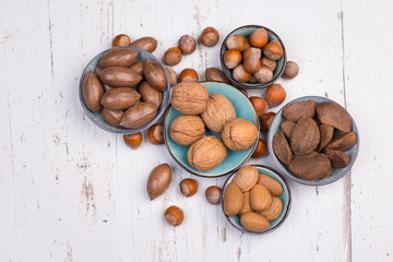 Walnuts, pecan nuts, almonds, hazelnuts and brazil nuts,mix of different kind of nuts on a textured background, copy space