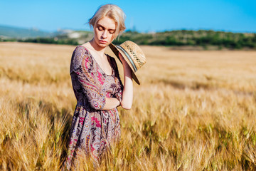 a woman farmer in field of wheat before the harvest