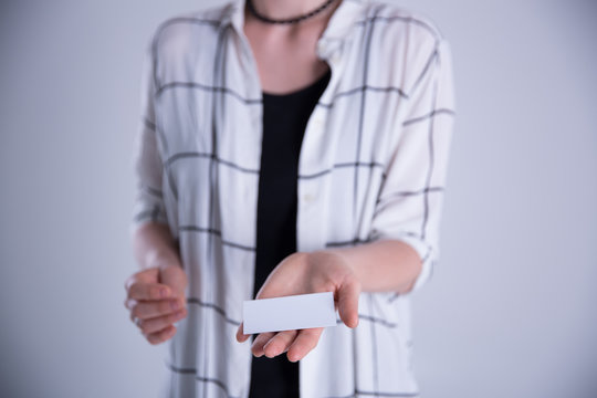 Young Woman Hand Showing Blank White Bussines Card.