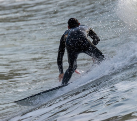 a surfer surf a wave in italy