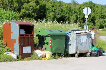 Three various large metal and plastic trash containers for ecologically sorting garbage for...
