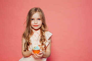 Obraz na płótnie Canvas beautiful little girl blonde with cake and candy portrait of food