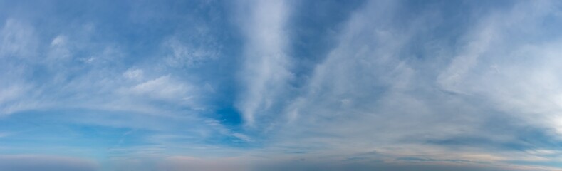 Fantastic clouds against blue sky, panorama