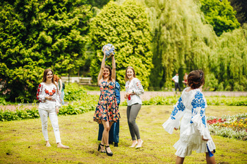 Naklejka na ściany i meble Amazing moment of throwing a bouquet at a wedding. Happy girl with a bouquet in her hands