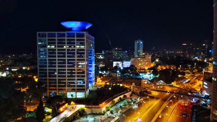 Obraz na płótnie Canvas Aerial view on Tel-Aviv. Urban night city never stops. Luxury building and tall towers