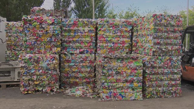 Compacted and compress aluminum  waste in a cube ready for recycling. Cans for recycling. Ecological conscience