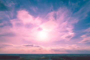 Colorful cloudy sky at sunset. Sunset over the countryside. Color gradient. Aerial view