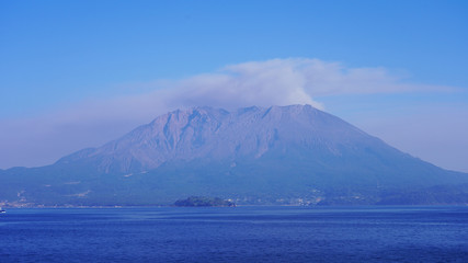 volcano eruption on the japanese islands on a sunny day. an active volcano smokes and throws volcanic dust into the air. Sakurajima volcano