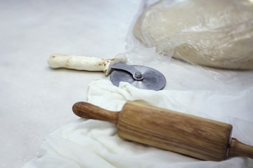 wooden rolling pin, pizza knife, bakery tools in bread shop, shallow depth of field