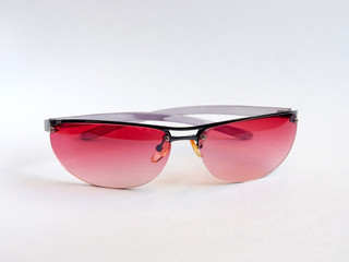 Sunglasses with pink glasses, women's accessory. Summer season, sea, beach.