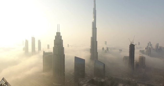 DUBAI, UAE - JANUARY 2, 2017: Aerial view of Burj Khalifa downtown Dubai at sunrise. The Burj al Khalifa is the tallest structure in the world, standing at 829.8 m (2,722 ft). Scenic foggy weather.