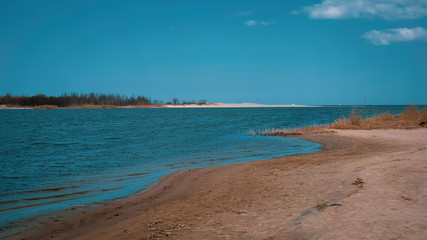waterside with sand in the spring
