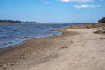 waterside with sand in the spring