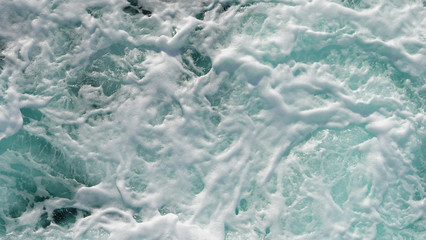 Texture of marine splashes. crashing ocean wave foam structure. Dark blue clear water. Ocean depth.