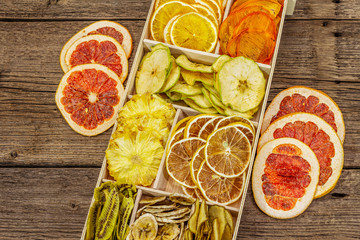 Assorted dried fruits. Healthy eating concept. Wooden box, old boards background