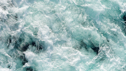 texture dark water of the deep ocean. sea ​​foam on the waves during a storm. natural...