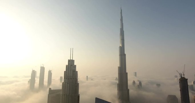 DUBAI, UAE - JANUARY 2, 2017: Aerial view of Burj Khalifa downtown Dubai at sunrise. The Burj al Khalifa is the tallest structure in the world, standing at 829.8 m (2,722 ft). Scenic foggy weather.