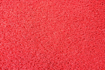 Red background plastic fiber parts,close up top view.