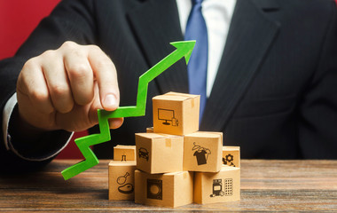Businessman holding a green arrow up over boxes. Tactics and strategy, marketing. Value added...