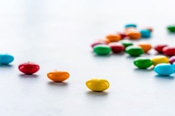 Colorful candy sweets on white background - closeup with selective focus