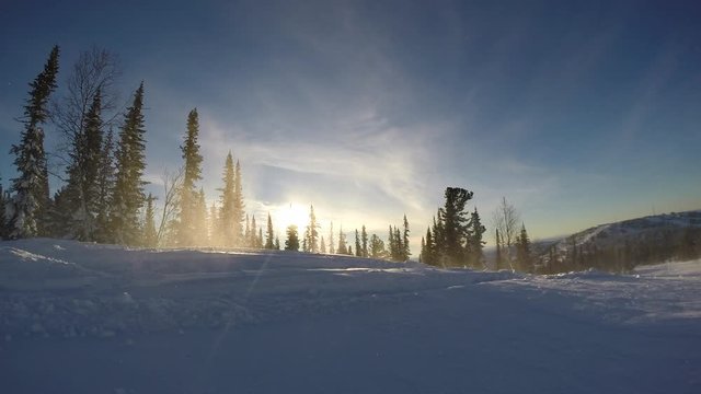 riding with jumps on mountain snowmobiles on fresh snow with swirls and splashes. snow motorcycles and winter tourism. snowmobile outdoor activities