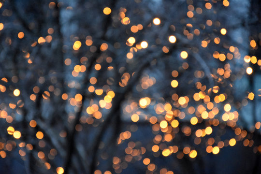 Golden light blur background stock images. Christmas lights in the city stock images. Elegant holiday background. Gold blurred bokeh wallpaper. Festive blur backdrop. Glossy golden background