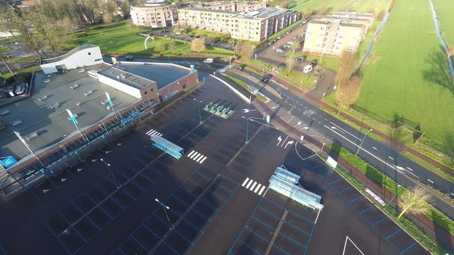 Jib down of large empty parking lot in front of supermarket