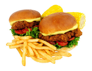 Southern fried chicken sandwiches with French fries and mayonnaise in brioche bread rolls isolated on a white background