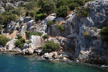 The remains of ancient buildings, the foundations of houses, steps and walls of houses on the island of Kekova in the mediterranean sea. Sights of Turkey.