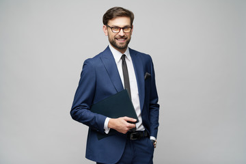 Portrait of a handsome young business man holding document folder