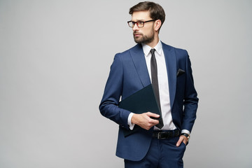 Portrait of a handsome young business man holding document folder