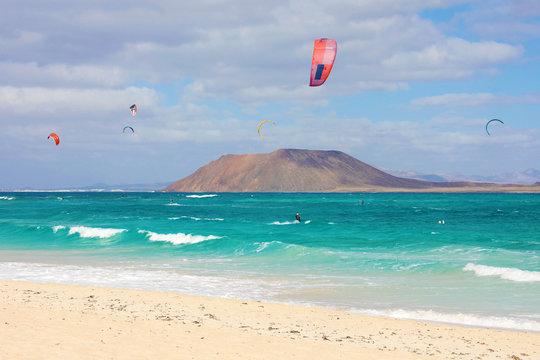 Beautiful view of Corralejo Dunas beach with Lobos Island and kitesurfers, Fuerteventura, Canary Islands