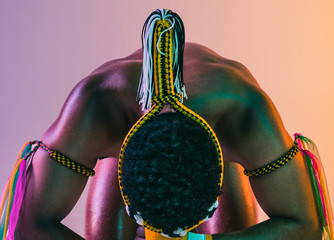 Muay thai. Young man exercising thai boxing on gradient background in neon light. Fighter...